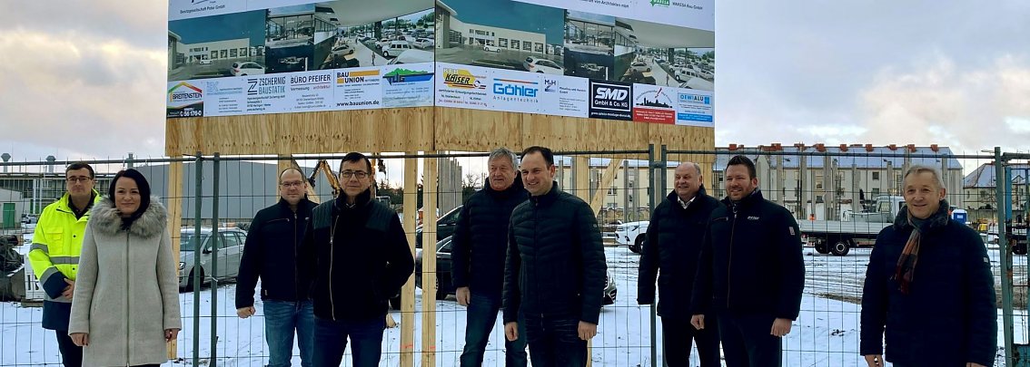 Gemeinsam mit Vertretern der Stadt, am Bau beteiligter Unternehmen sowie Dessauer Mitarbeitern gaben Helmut und Andreas Peter (3. und 4. von rechts) mit der Enth&uuml;llung des Baustellenschildes den symbolischen Startschuss f&uuml;r das Bauvorhaben.