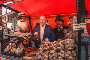 Knoblauchstand mit mehreren Personen dahinter, die meisten in Kost&uuml;men.


